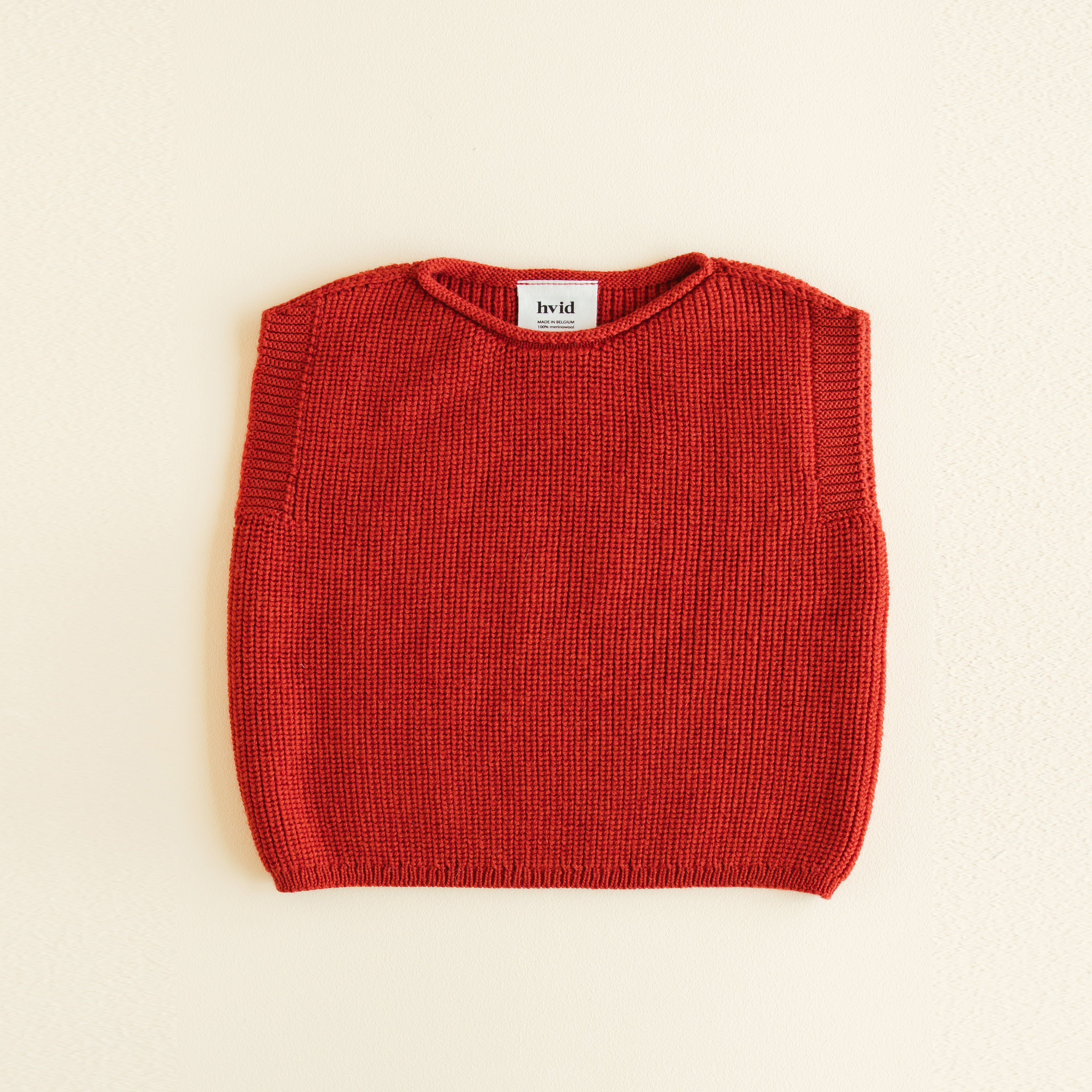HVID seamless knitted baby vest in extra fine Italian merino wool with a unique stretch collar design for easy dressing in red