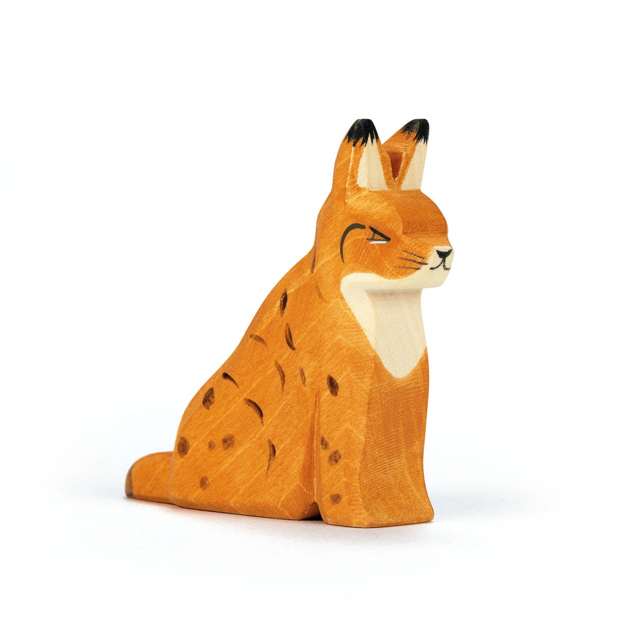 Ostheimer handcrafted wooden sitting lynx toy, painted in natural tones, ideal for imaginative play and storytelling.
