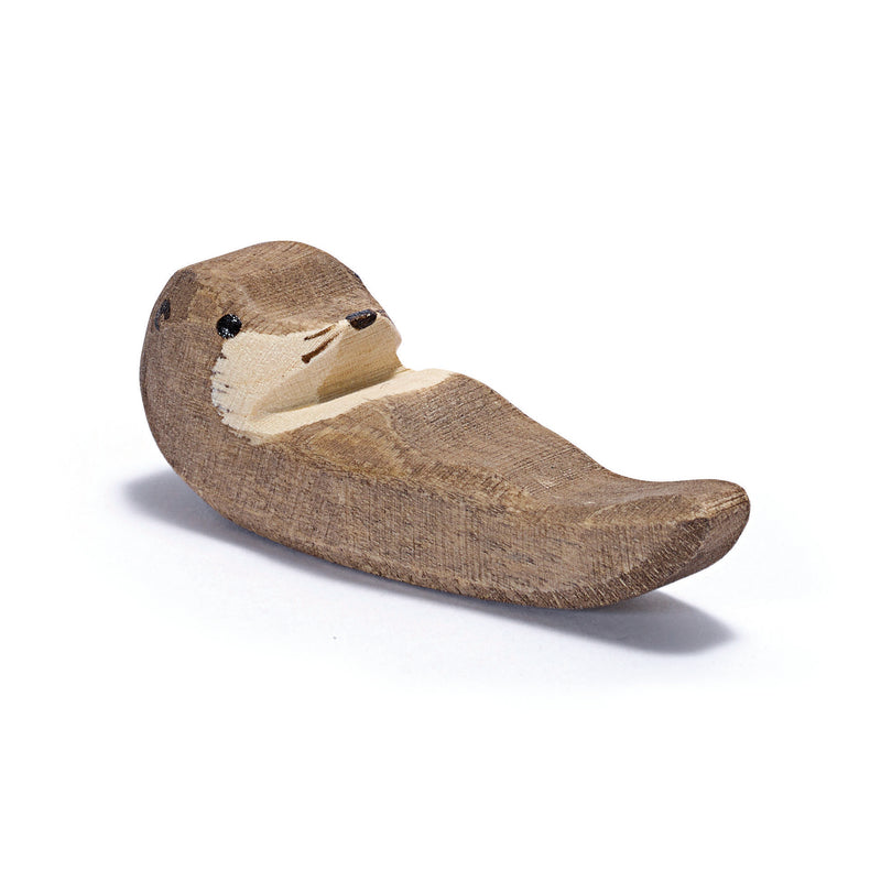 Handcrafted wooden sea otter figure by Ostheimer, depicting a playful young otter swimming and cracking shells. Made with sustainable materials and non-toxic paints.