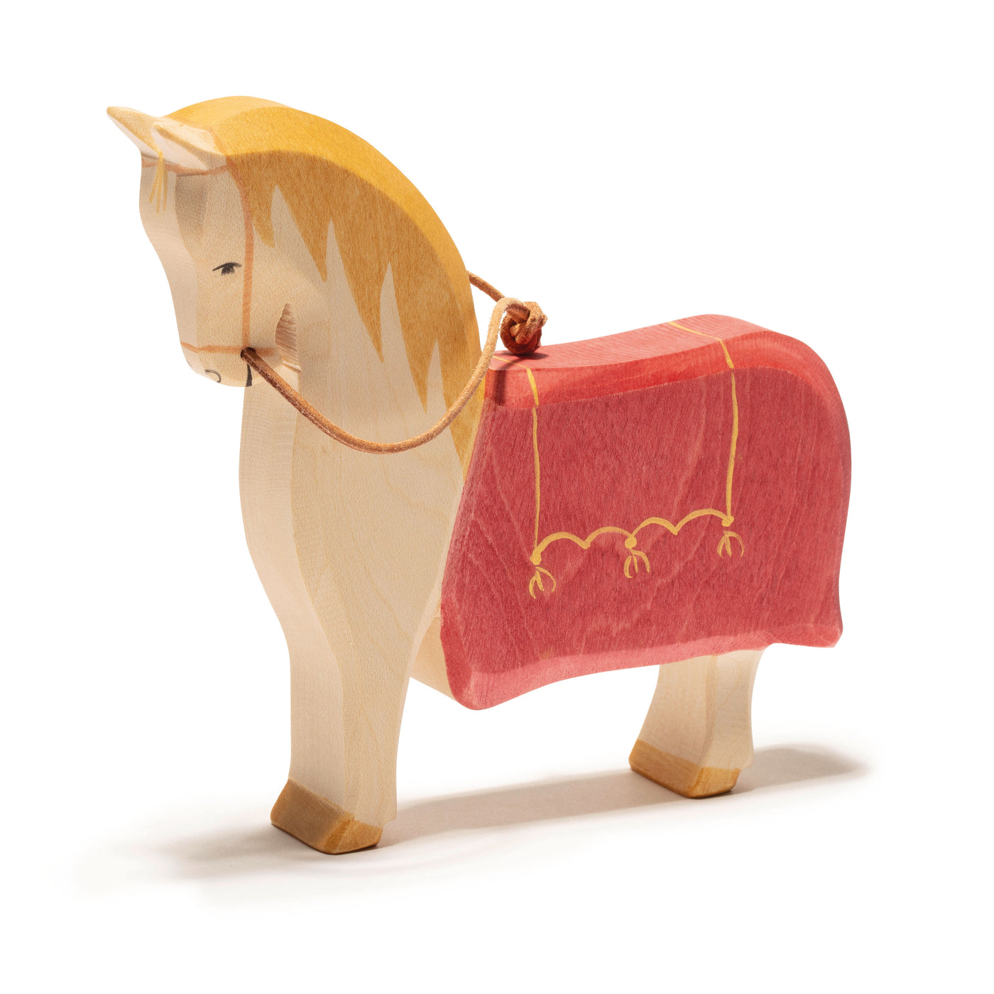 Handcrafted wooden St. Martin's horse by Ostheimer, featuring a golden mane and red saddle cloth with yellow details, perfect for imaginative play and storytelling