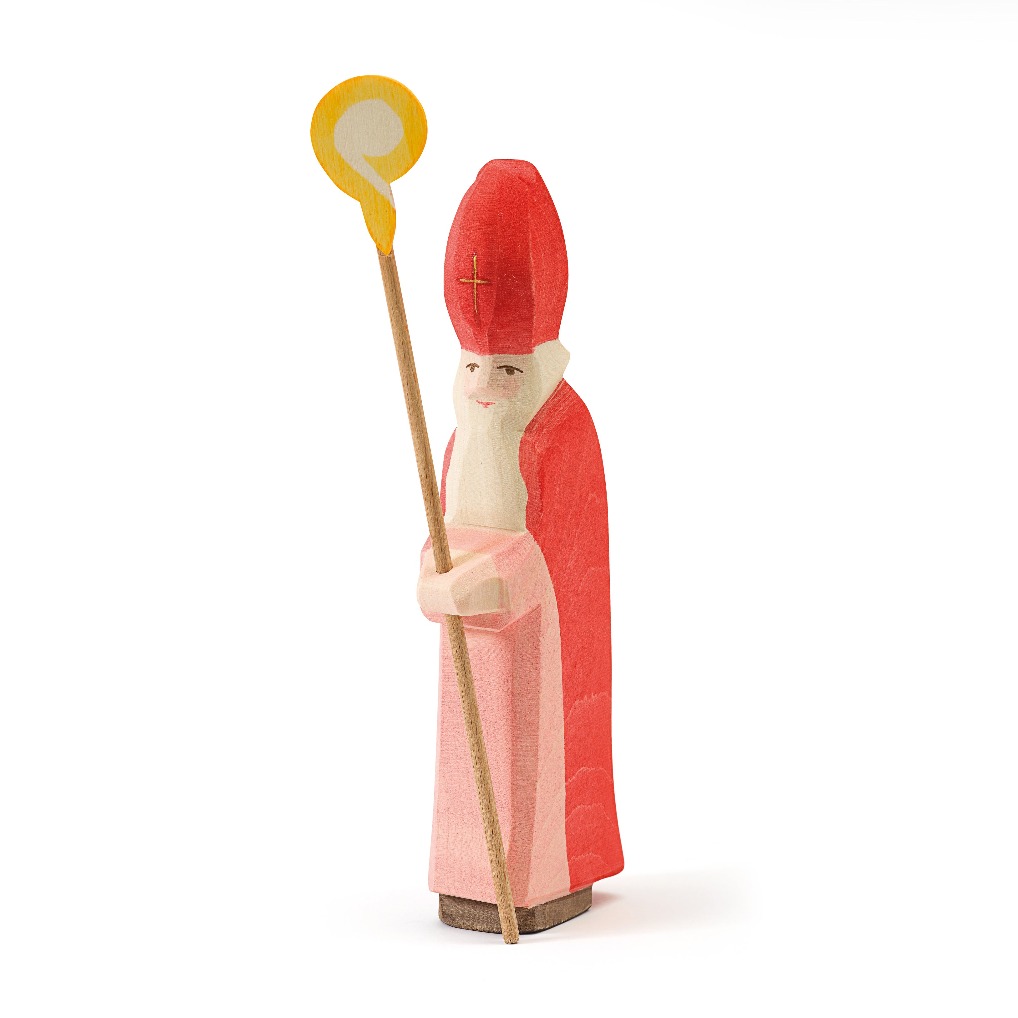 Handcrafted wooden St. Nicholas figurine with mitre and staff, symbolizing kindness and generosity for seasonal play and traditions.