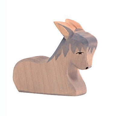 Handcrafted wooden donkey in resting pose by Ostheimer, ideal for nativity scenes and imaginative storytelling