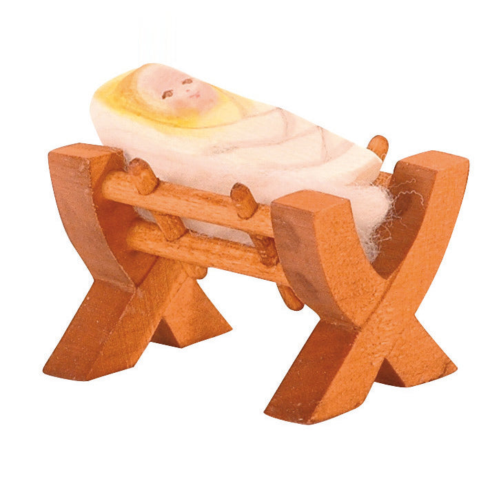 Handcrafted wooden kid in crib by Ostheimer, perfect for nativity displays and Christmas storytelling