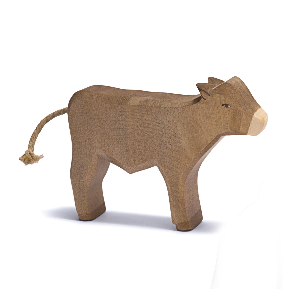 Handcrafted wooden Ostheimer standing ox figure with rope tail, ideal for Nativity scenes or farm play.