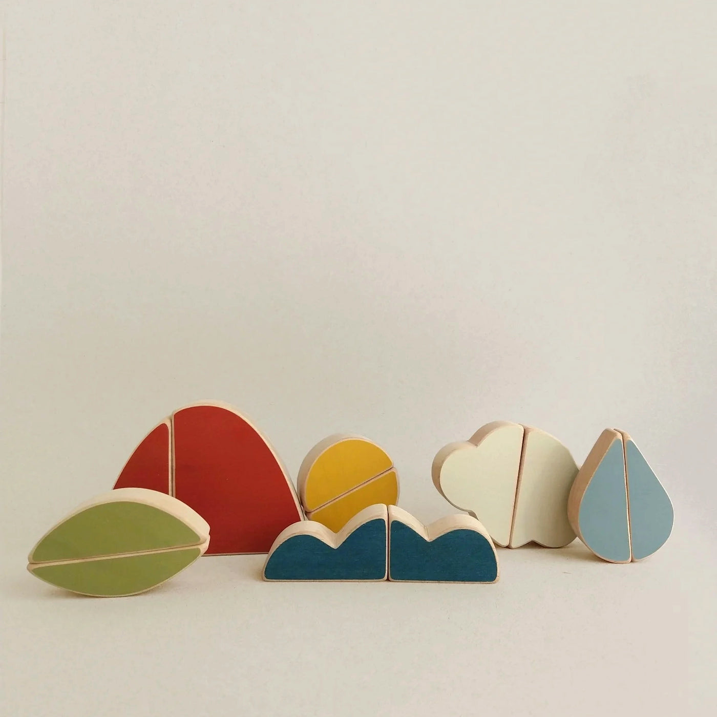 Earth Air and Water Puzzle Toy featuring mountain, cloud, and leaf shapes. Handcrafted from FSC-certified beech wood with non-toxic paints. Inspires sensory exploration and fine motor skills.