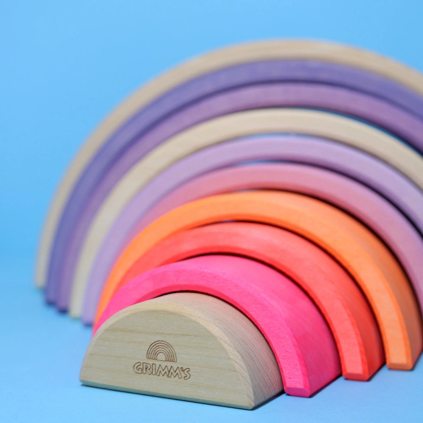 Grimms Neon Rainbow – 10-piece wooden stacking toy in neon and natural tones, handcrafted from linden wood for open-ended creative play