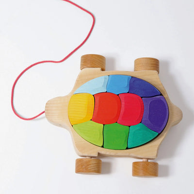 Grimms Rainbow Turtle – colorful wooden pull toy with 10 stacking blocks made from basswood, perfect for toddlers learning to walk