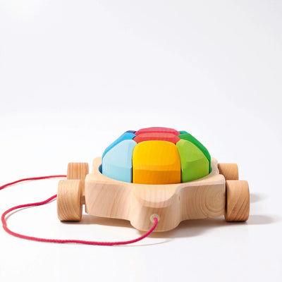 Grimms Rainbow Turtle – colorful wooden pull toy with 10 stacking blocks made from basswood, perfect for toddlers learning to walk