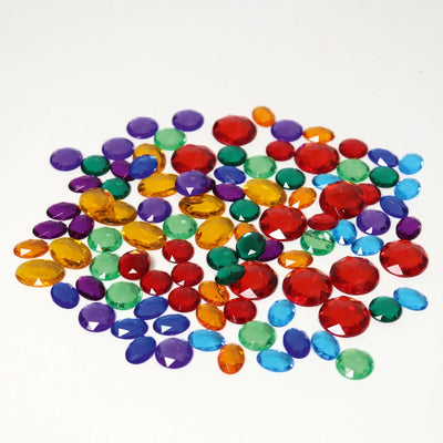 Set of 100 Grimms small acrylic glitter stones in assorted colours inside a palm leaf shell, shimmering loose parts for creative play