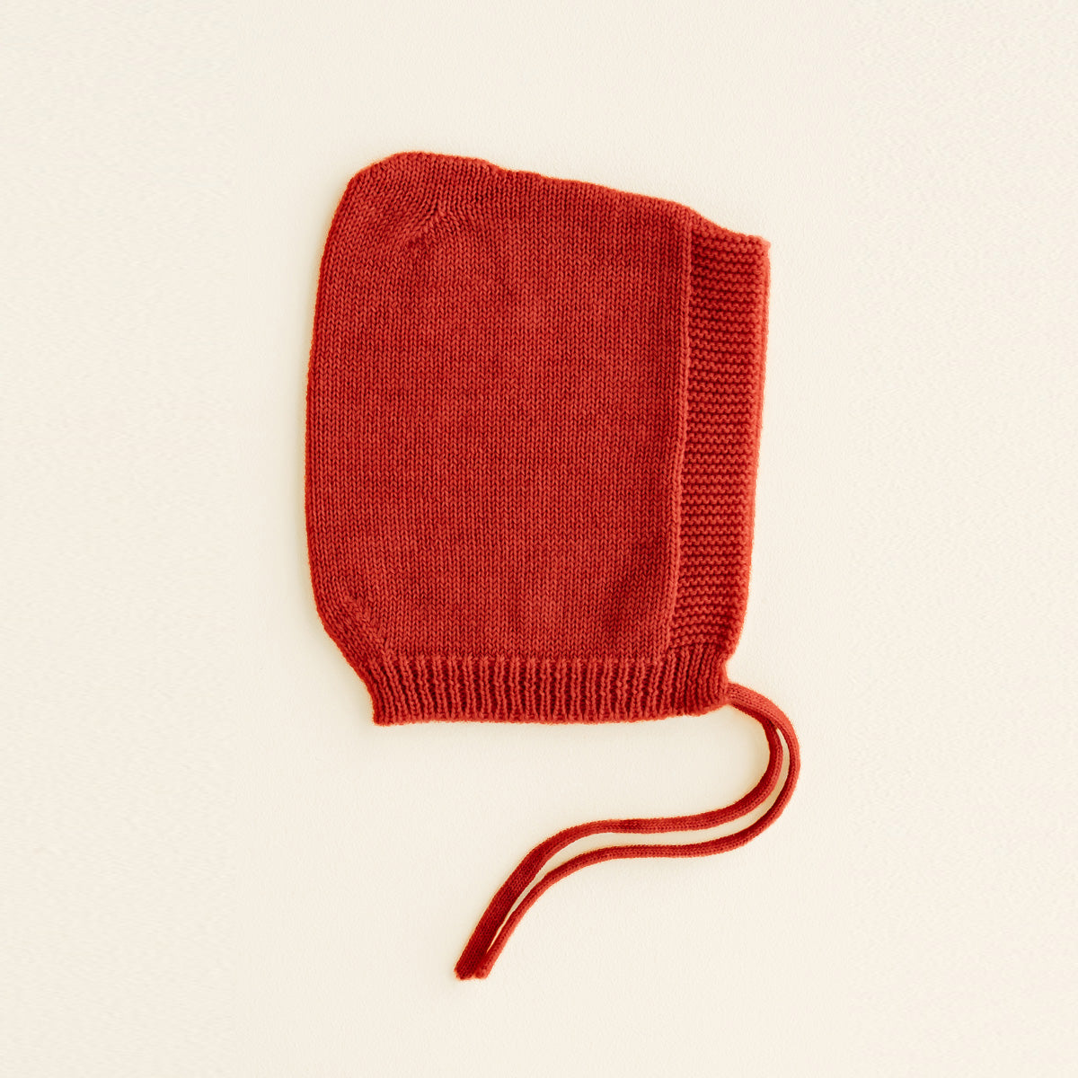 HVID seamlessly knitted baby bonnet in extra fine Italian merino wool with a cute peak detail in red