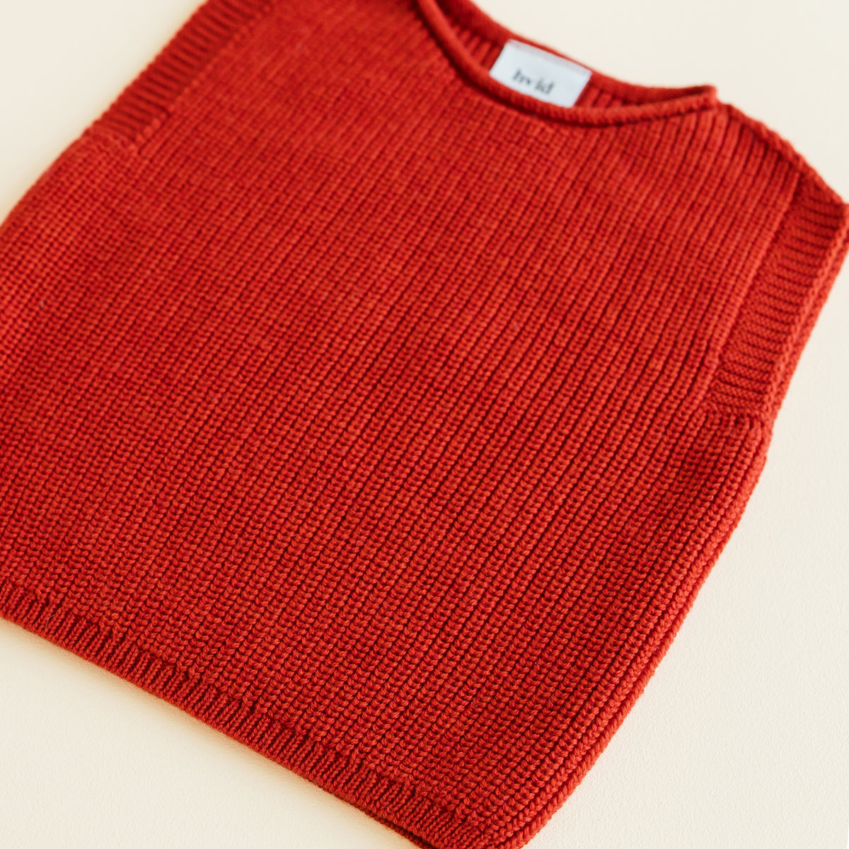 HVID seamless knitted baby vest in extra fine Italian merino wool with a unique stretch collar design for easy dressing in red