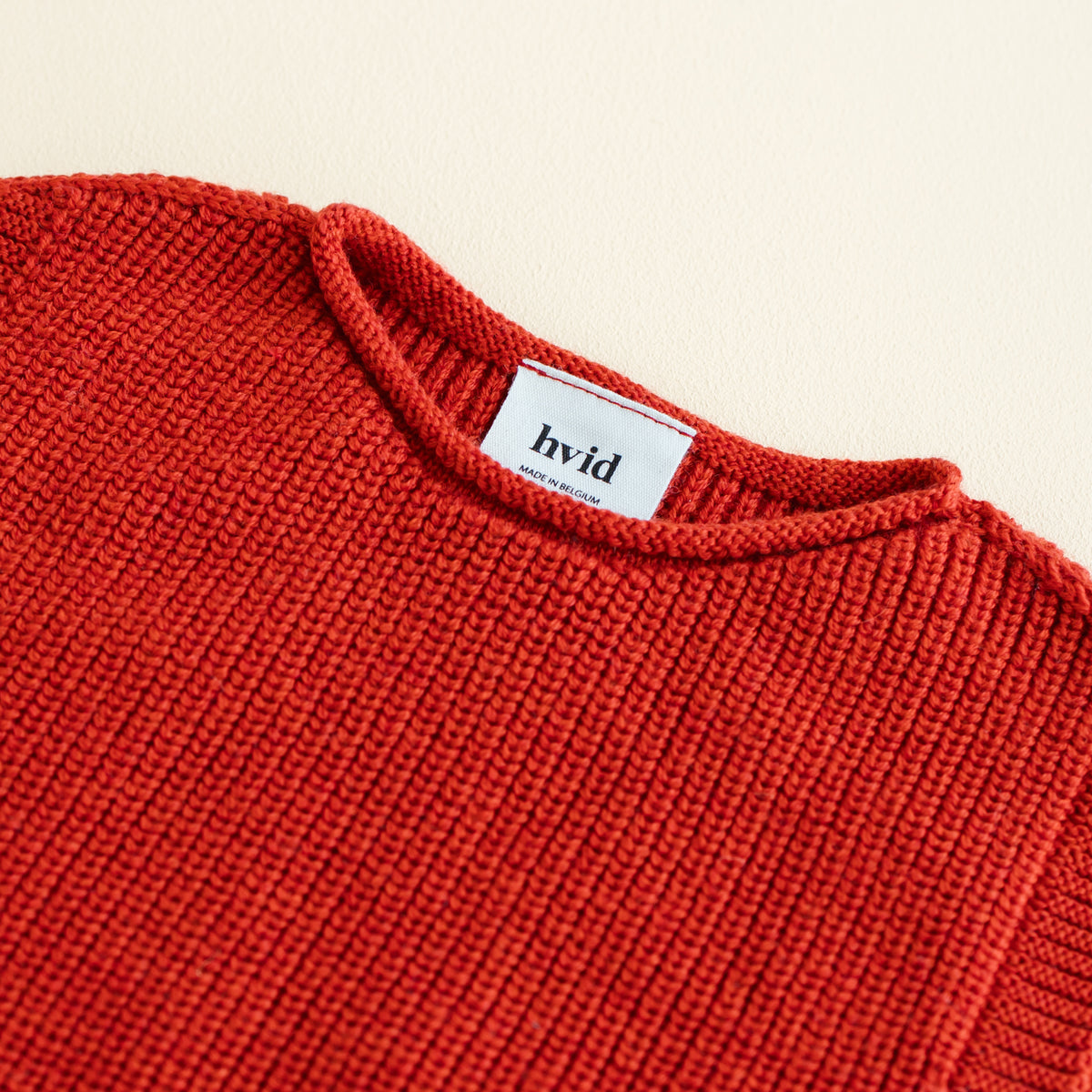 HVID seamless knitted baby vest in extra fine Italian merino wool with a unique stretch collar design for easy dressing in red