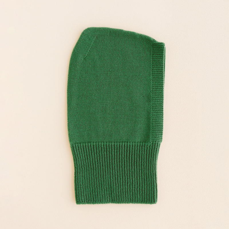 Hvid Balaclava in Grass – soft merino wool kids balaclava with ribbed neck and playful peak, knitted in Belgium to keep little ones warm and comfy.