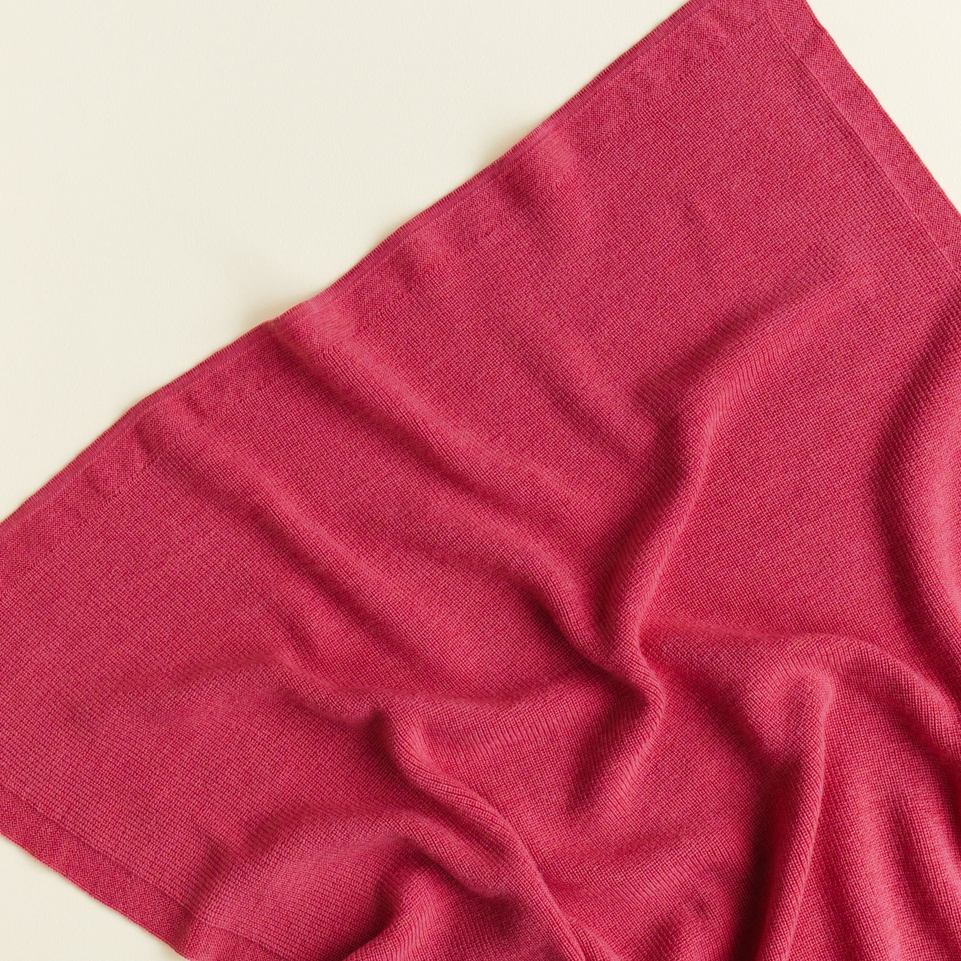 Hvid’s Felix rib-knit baby blanket in lollipop pink, made from 100% extra fine Italian merino wool, perfect for babies and toddlers with sensitive skin