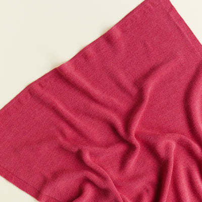 Hvid’s Felix rib-knit baby blanket in lollipop pink, made from 100% extra fine Italian merino wool, perfect for babies and toddlers with sensitive skin