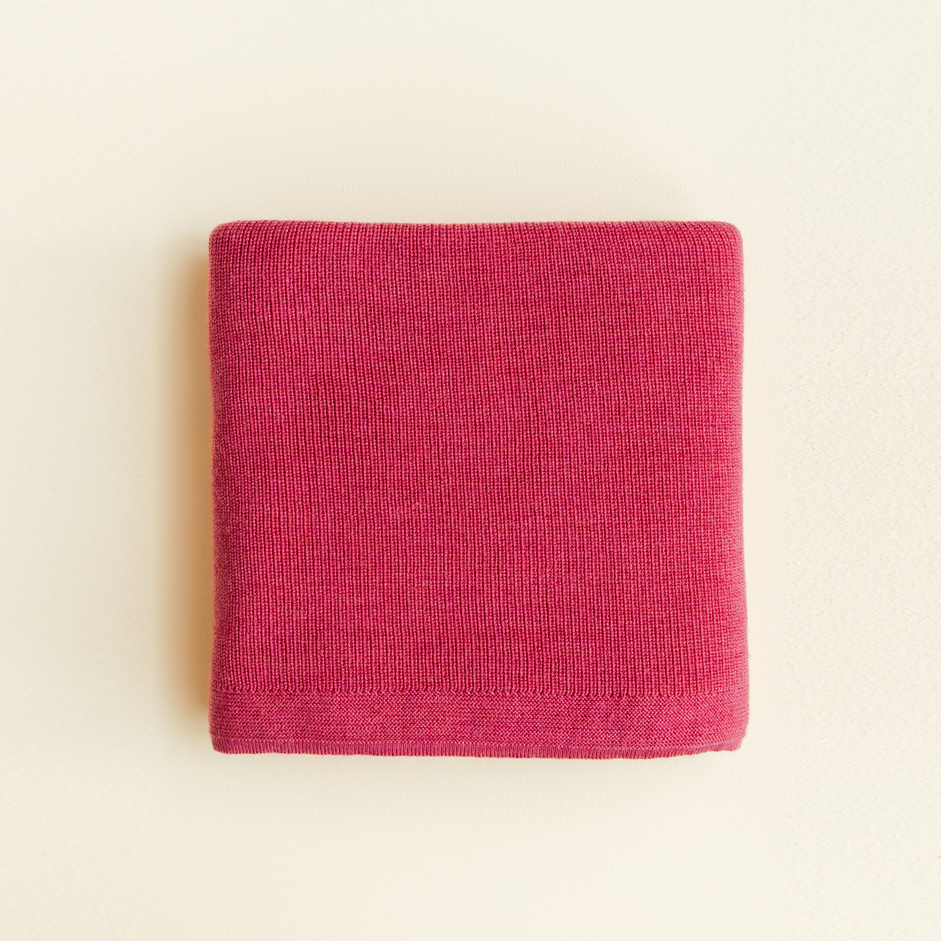 Hvid’s Felix rib-knit baby blanket in lollipop pink, made from 100% extra fine Italian merino wool, perfect for babies and toddlers with sensitive skin