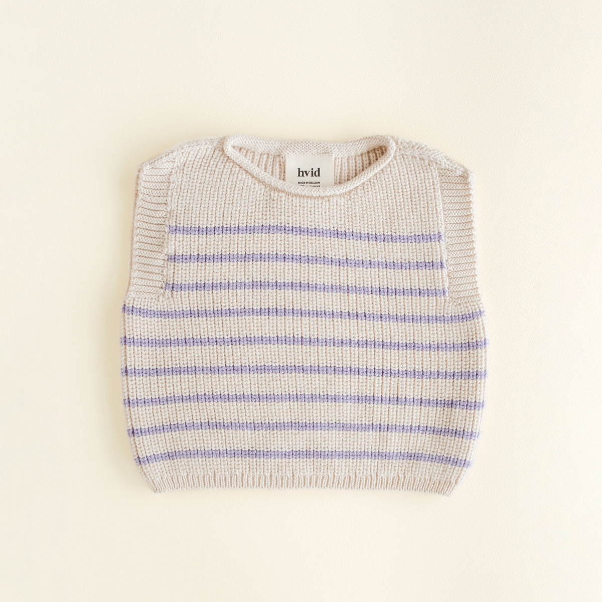 Hvid Vest Harvey in cream lila stripe, a seamless baby vest made from extra fine merino wool with a soft fisherman’s rib and elastic neckline, knitted in Belgium.