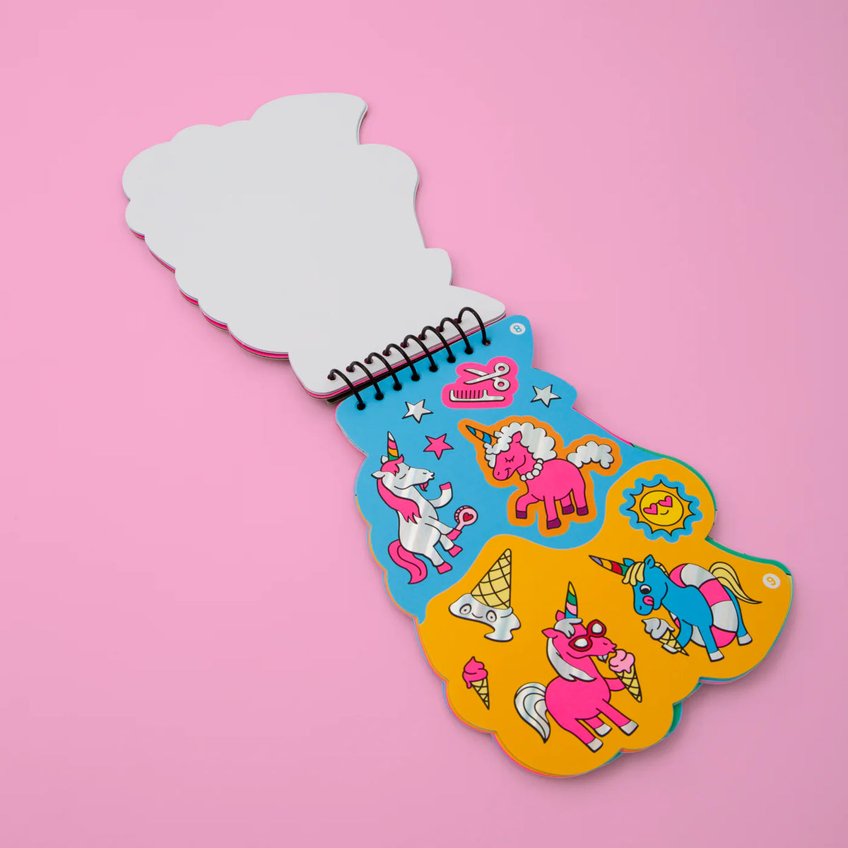 A colorful OMY activity book with neon, gold, and holographic stickers, designed to inspire creativity in children aged 4 and up. Perfect for imaginative play and easy to carry anywhere.