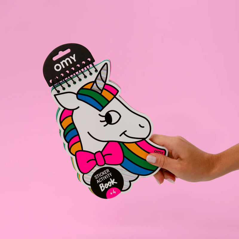 A colorful OMY activity book with neon, gold, and holographic stickers, designed to inspire creativity in children aged 4 and up. Perfect for imaginative play and easy to carry anywhere.