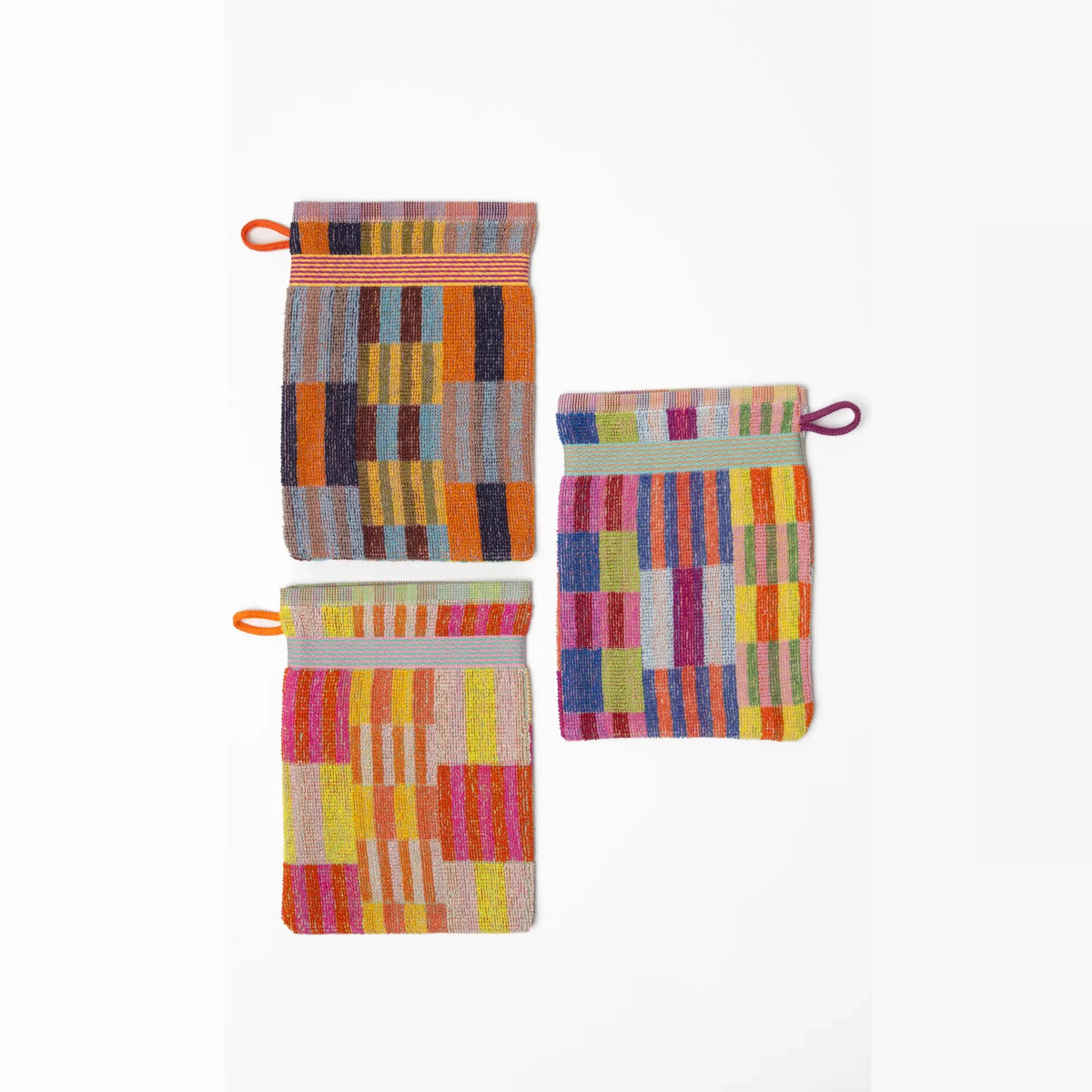 3 pack wash cloths by Foekje Fleur. Colorful cotton textile made from leftover yarns, featuring unique woven color combinations and a hanging label, photographed folded on a neutral background.