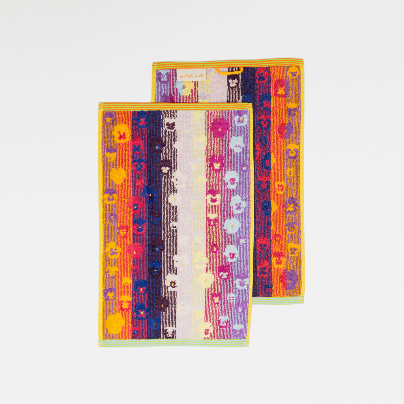 Set of two sustainable colorful guest towels with pansy pattern made from leftover cotton yarns with velour finish – made in Portugal