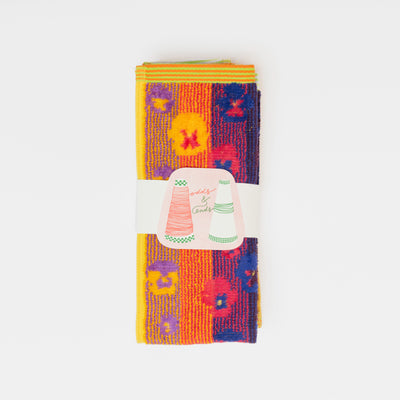 Set of two sustainable colorful guest towels with pansy pattern made from leftover cotton yarns with velour finish – made in Portugal