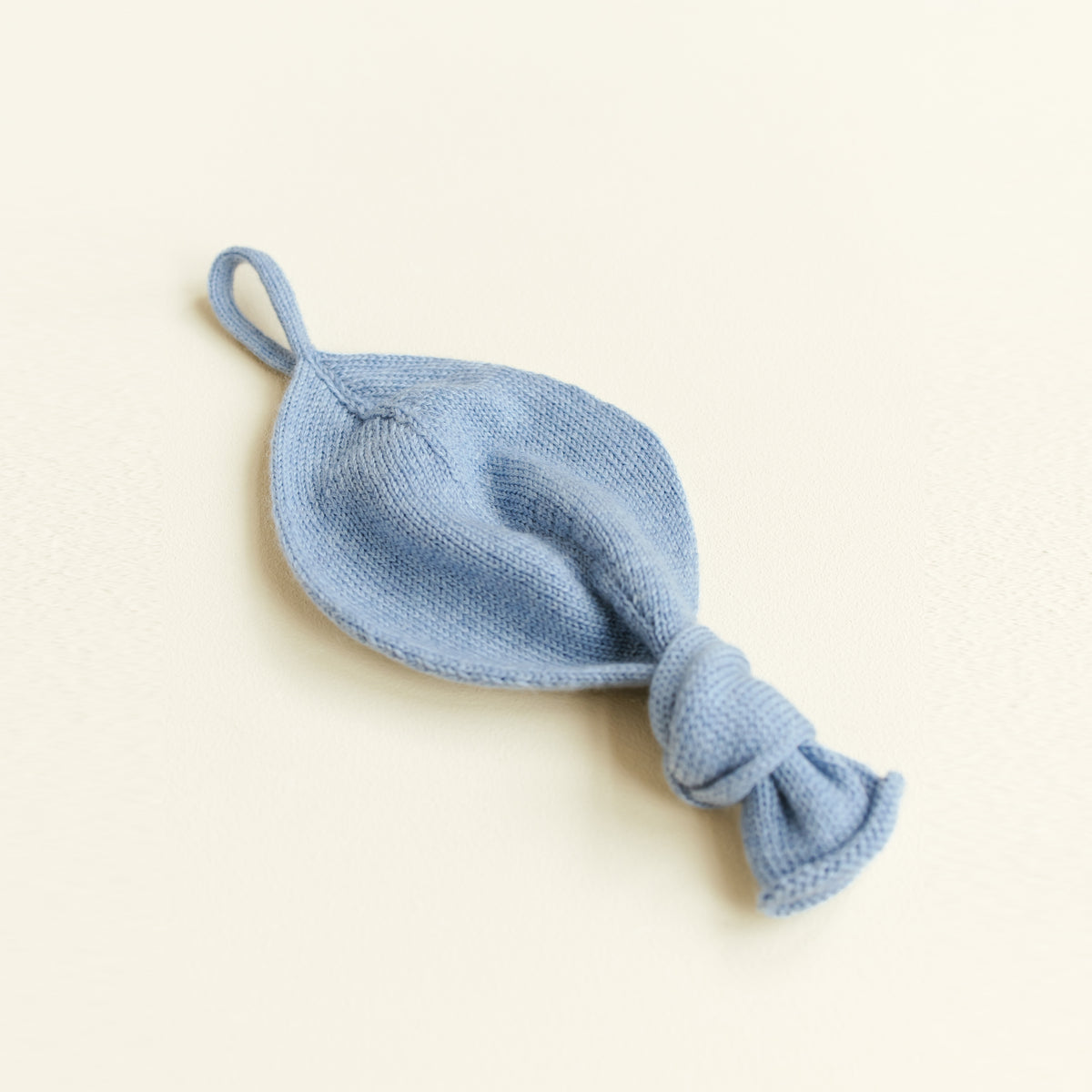 Soft Titi pacifier holder made from 100% merino wool in light blue, ideal baby comforter for sensitive skin, handmade in Belgium