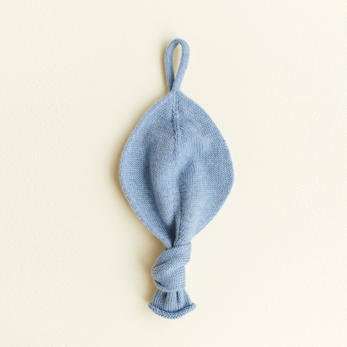 Soft Titi pacifier holder made from 100% merino wool in light blue, ideal baby comforter for sensitive skin, handmade in Belgium