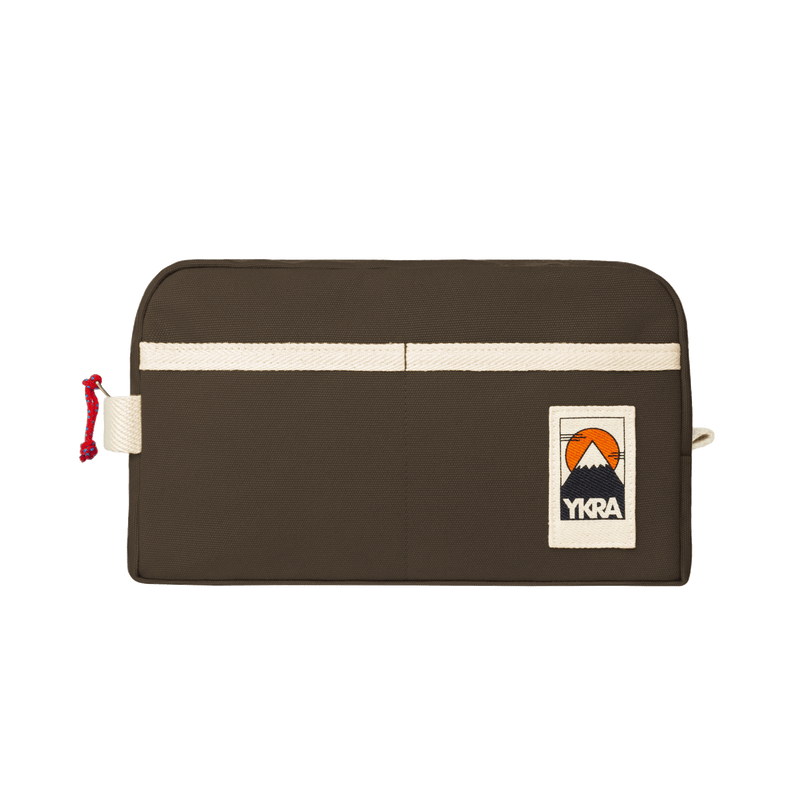 YKRA Dopp Pack toiletry bag made from durable cotton canvas, featuring outer pockets and a carrying handle.