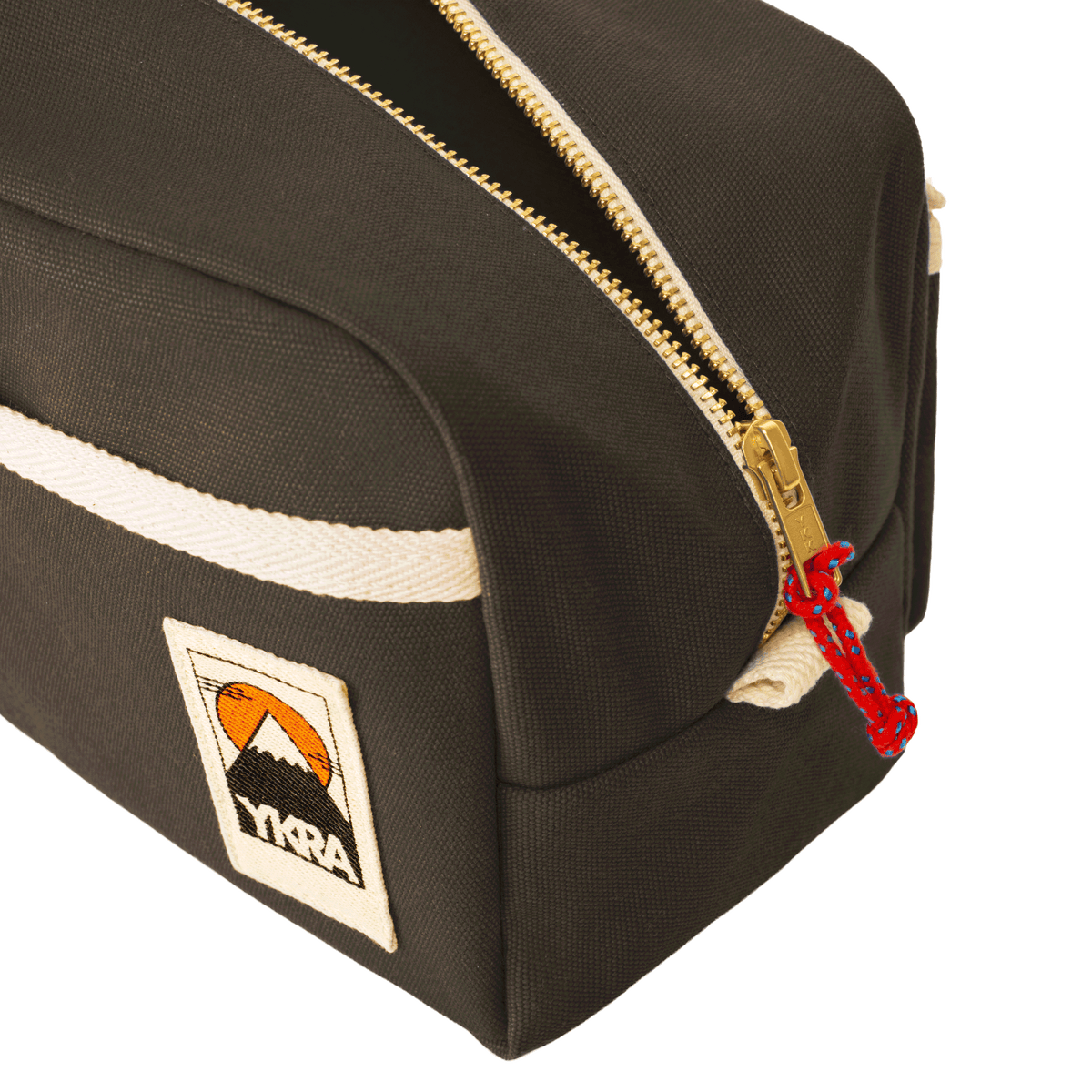 YKRA Dopp Pack toiletry bag made from durable cotton canvas, featuring outer pockets and a carrying handle.