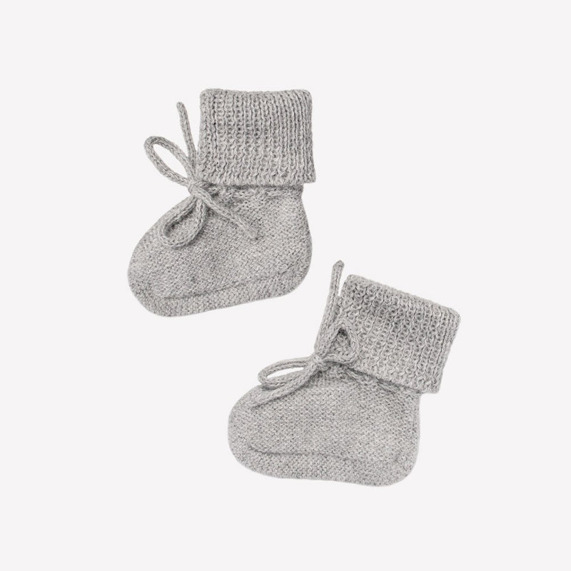 Hand-knitted baby booties made of pure baby alpaca wool by Main Sauvage, hypoallergenic, thermoregulating, and eco-friendly.