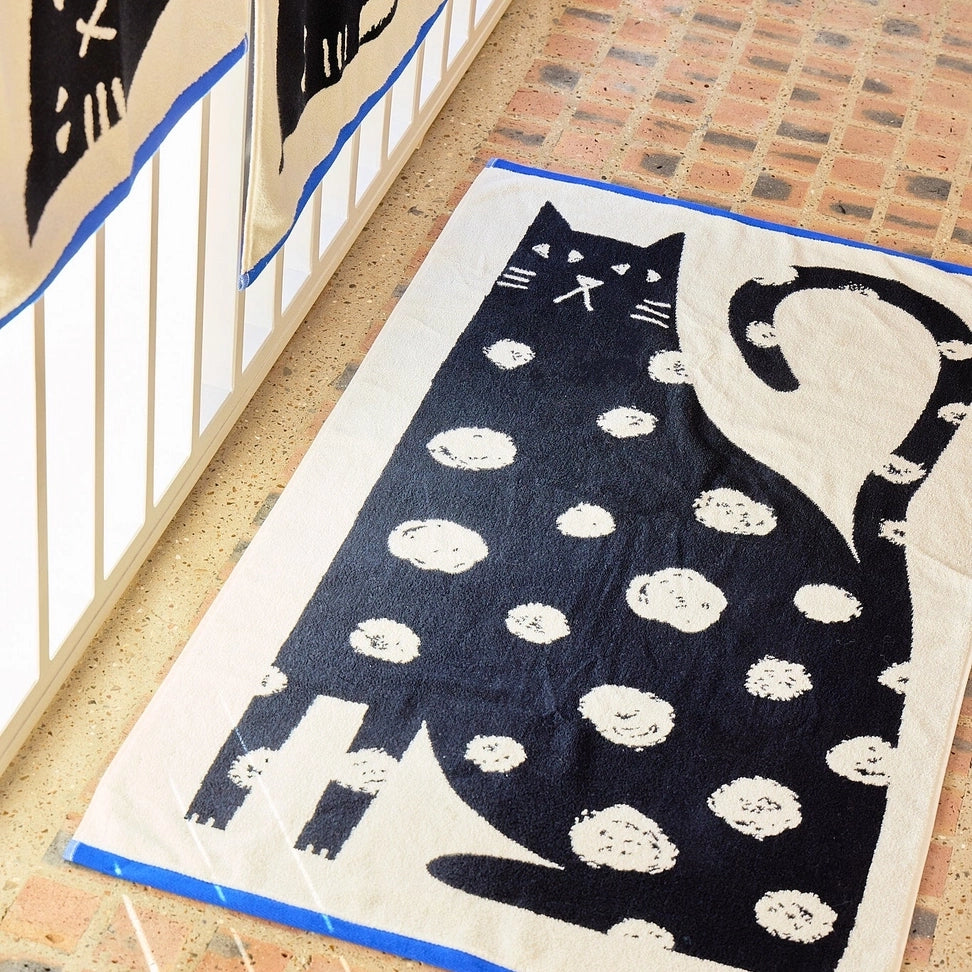 Donna Wilson Lazy Cat Bath Towel – large super soft 100% cotton jacquard bath towel featuring a smug spotty cat design, made in Portugal