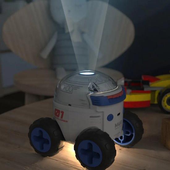 MOB Space Rover Explorer, a mini space vehicle light projector for kids, featuring 24 illustrated slides of key milestones in space exploration and a 24-page educational booklet. Includes Leo, an intergalactic guide, to inspire curiosity and creativity. Doubles as a soft nightlight with up to 8 hours of battery life. Perfect for children’s bedrooms or as a decorative nightlight. Designed by MOB, a brand known for blending modern aesthetics with functionality to inspire joy and wonder.