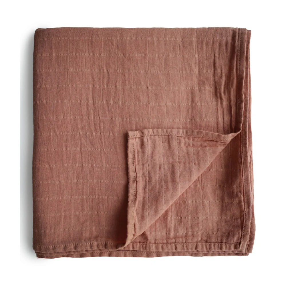 Cozy and soft organic cotton baby swaddle by Mushie in cognac color, perfect for swaddling, nursing, and cuddling. Made from 100% organic muslin cotton, gentle on baby’s skin, 120x120cm