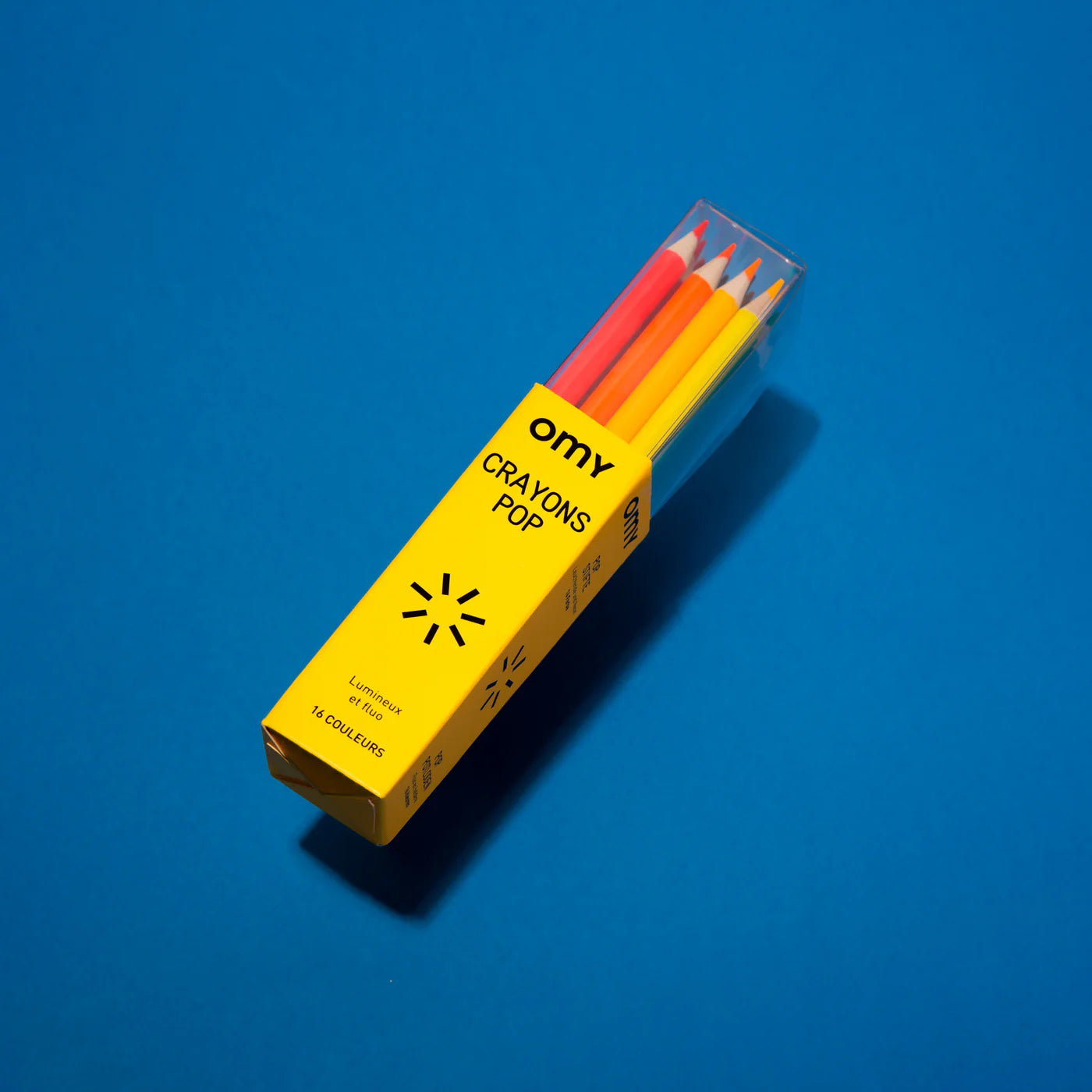 Box of 16 OMY colored pencils in neon and shiny colors, made of round wooden barrels with box that doubles as a pencil holder