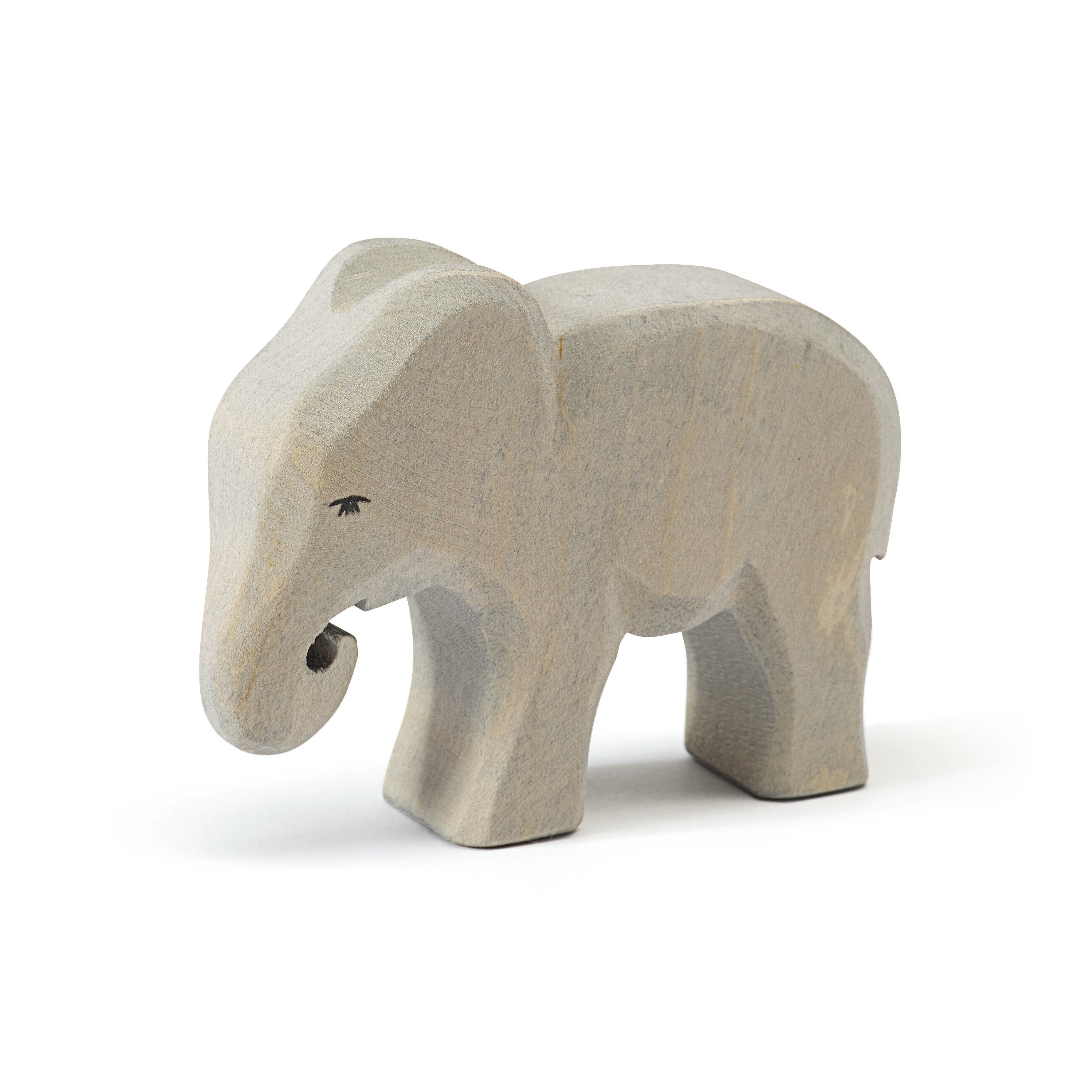 Handcrafted Ostheimer wooden eating baby elephant figure, made from natural wood with a non-toxic finish, perfect for open-ended play and sensory exploration