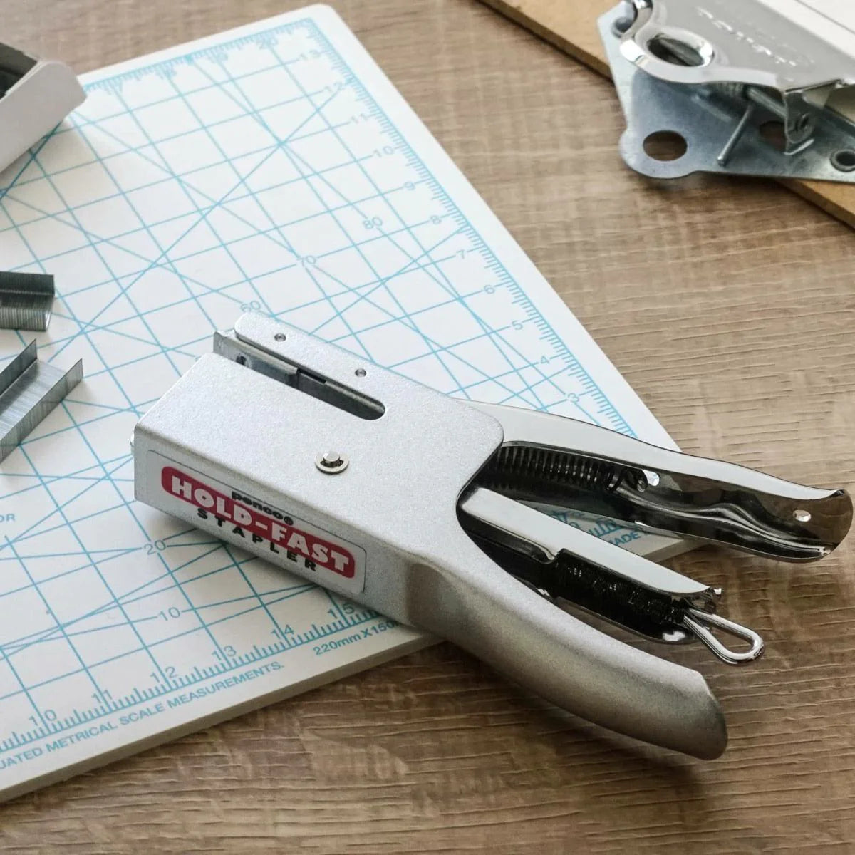 Compact Penco Silver Stapler, compatible with No. 10 staples, featuring a sleek, industrial design with comfortable grip handle, perfect for a nostalgic touch to any workspace