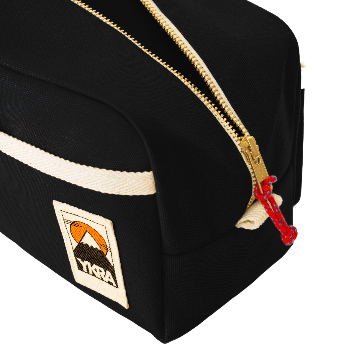 YKRA Dopp Pack toiletry bag made from durable cotton canvas, featuring outer pockets and a carrying handle.