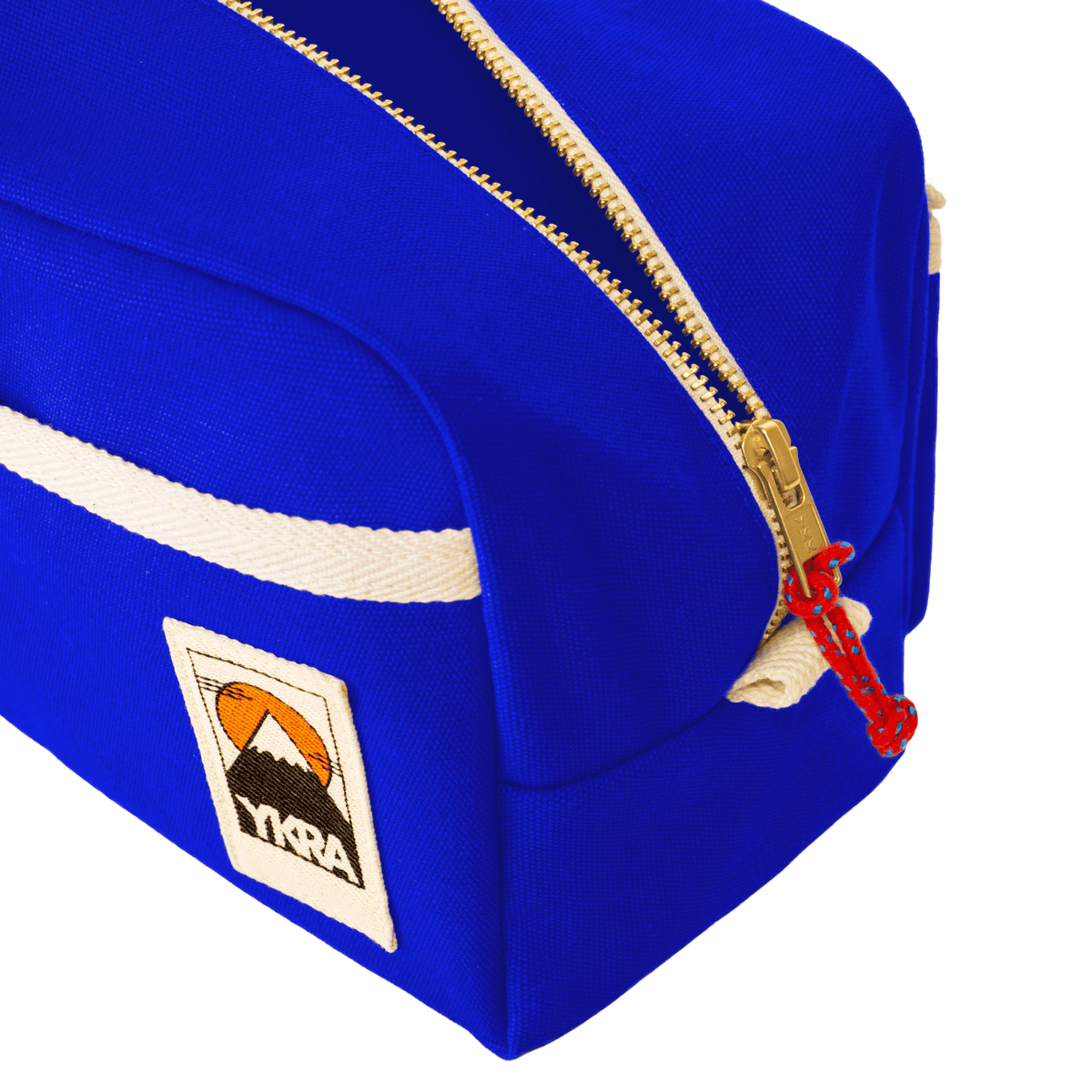 YKRA Dopp Pack toiletry bag made from durable cotton canvas, featuring outer pockets and a carrying handle.