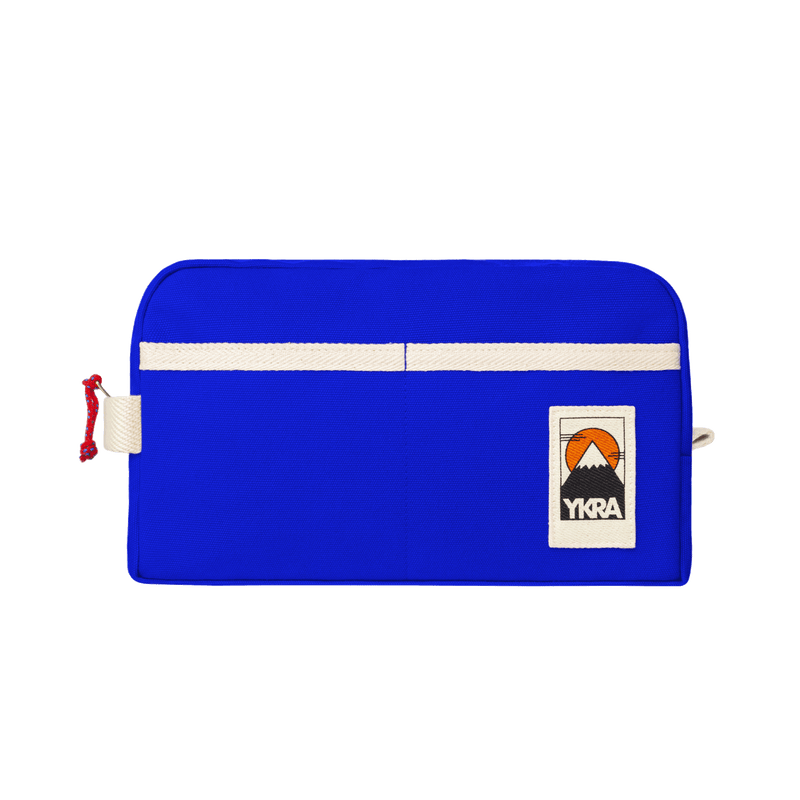 YKRA Dopp Pack toiletry bag made from durable cotton canvas, featuring outer pockets and a carrying handle.