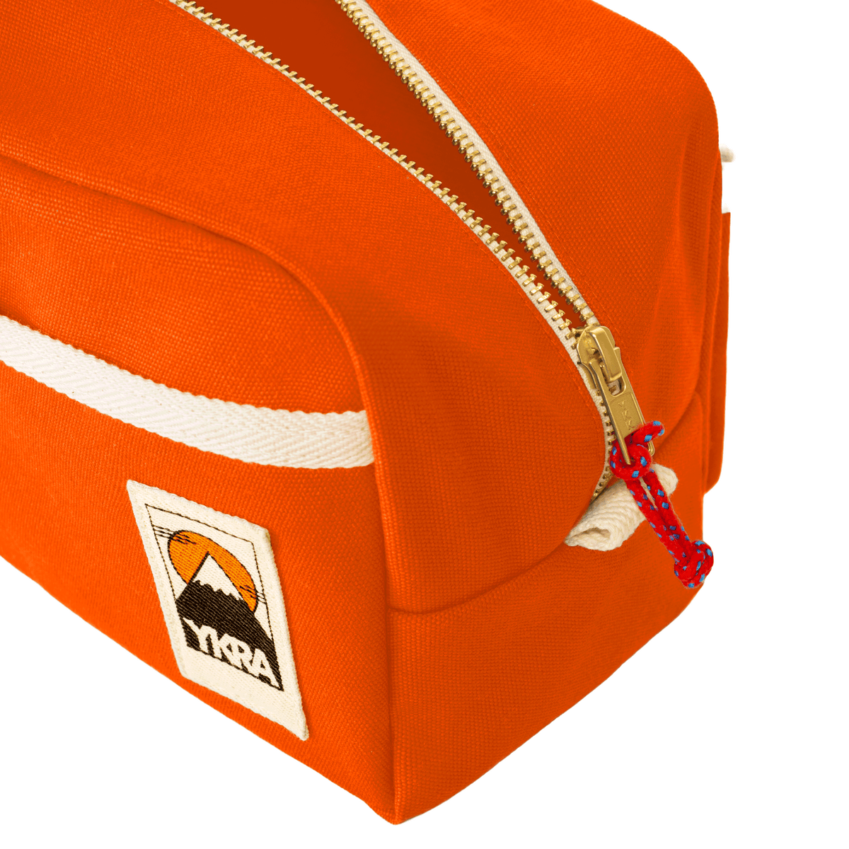 YKRA Dopp Pack toiletry bag made from durable cotton canvas, featuring outer pockets and a carrying handle.