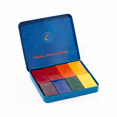 Open metal box with 8 Stockmar block crayons in assorted colors.