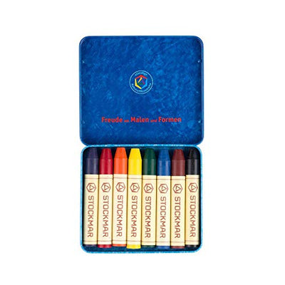 Set of 8 Stockmar crayons displayed in an open metal tin, showing vibrant colors.